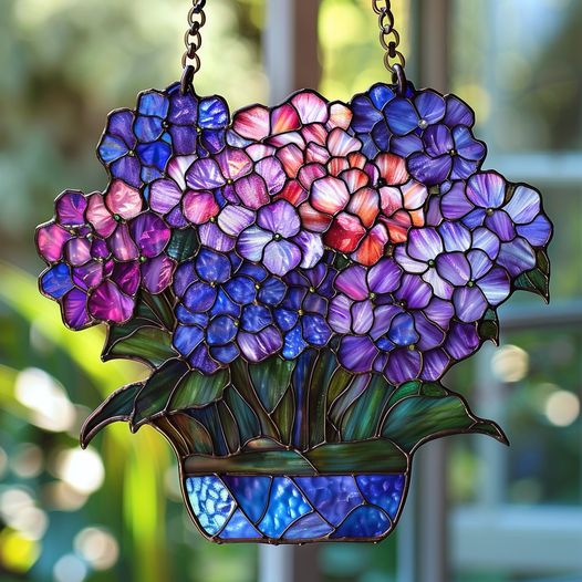 Stunning purple stained glass hydrangeas 🌸 create a vibrant and artistic hanging piece.