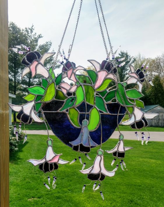 Nature’s grace preserved in colorful glass—this hanging masterpiece brightens up any garden view!