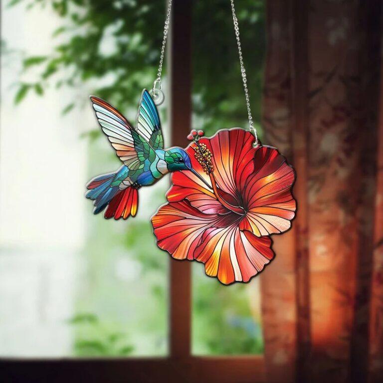 A stunning stained glass piece featuring a hummingbird in mid-flight towards a vibrant red hibiscus flower, perfectly capturing the harmony of nature.